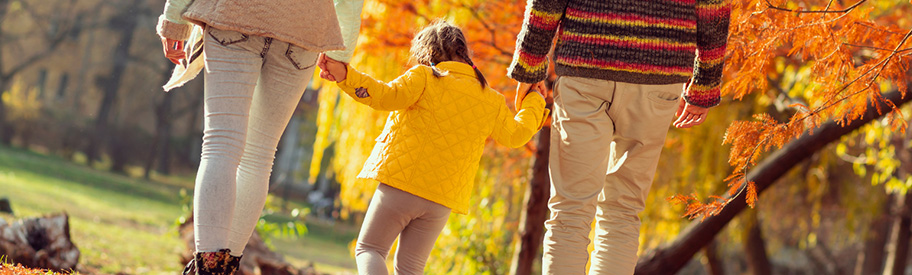 vrouw, kind en man aan het wandelen in herfstbos